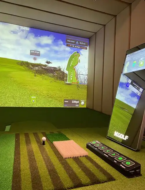 Golfer practicing swing with indoor portable simulator