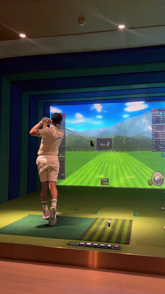 Indoor entertainment room with golf simulator setup