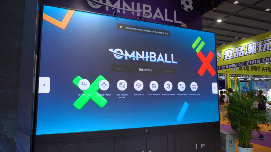 Kids practicing pickleball using multi-sport trainer wall projection