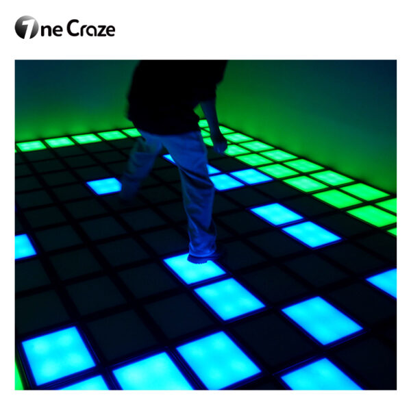Participants stepping on LED tiles in team challenge game