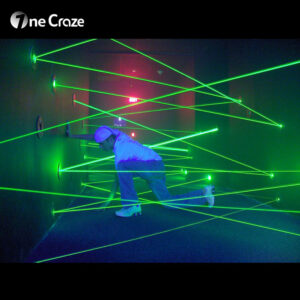 Players running through diagonal laser beams in Activate LED Game maze challenge