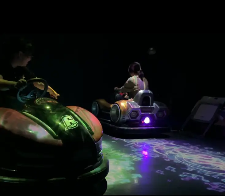 AR interactive bumper cars system in immersive floor projection game arena
